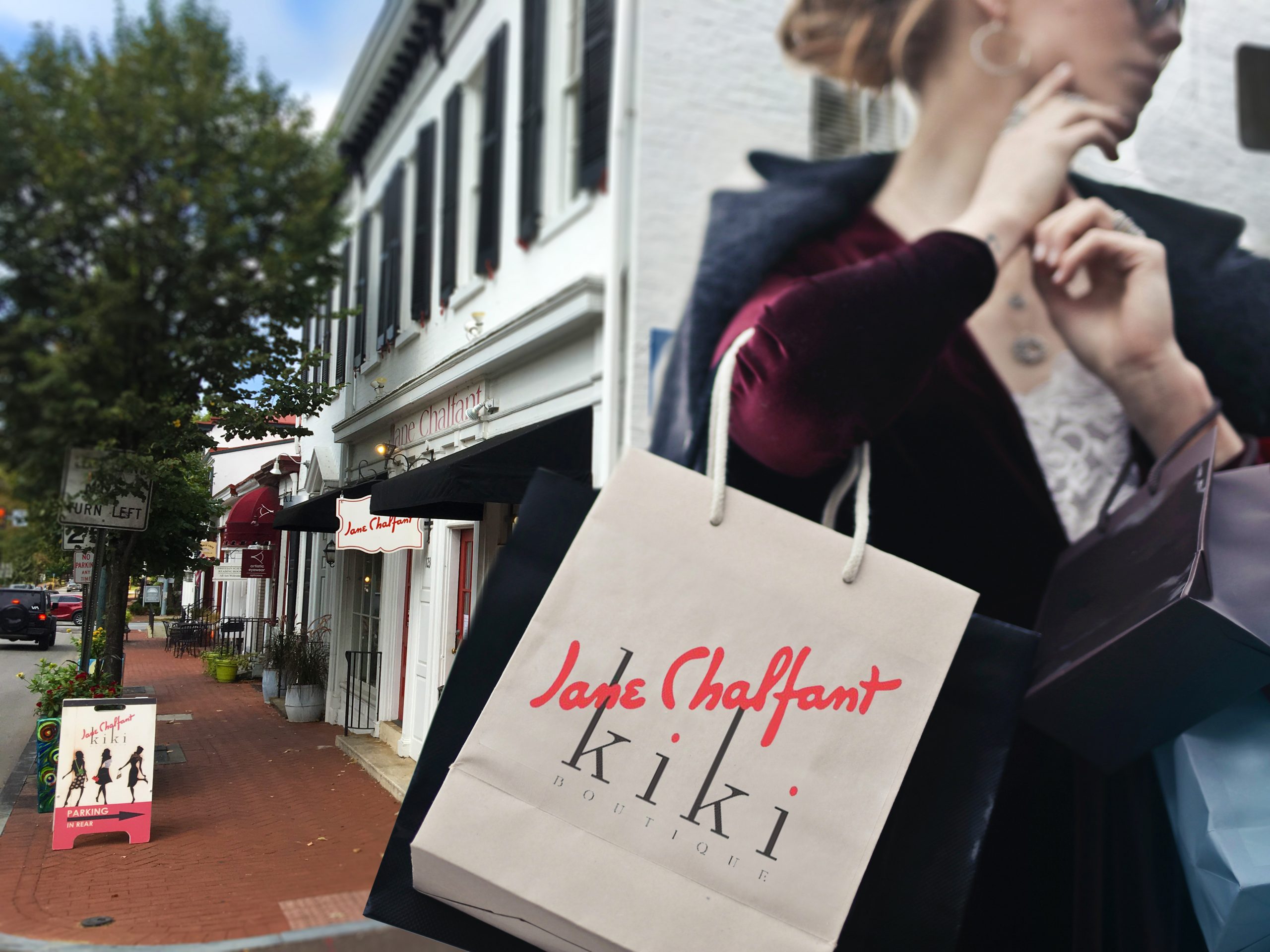 Woman in a red dress and winter coat with shopping bags looking at retail space